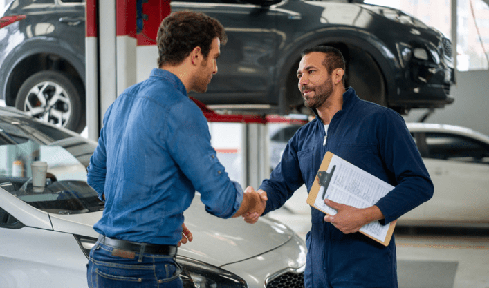 2 Men shaking hands over Shop management in Identifix repair shop